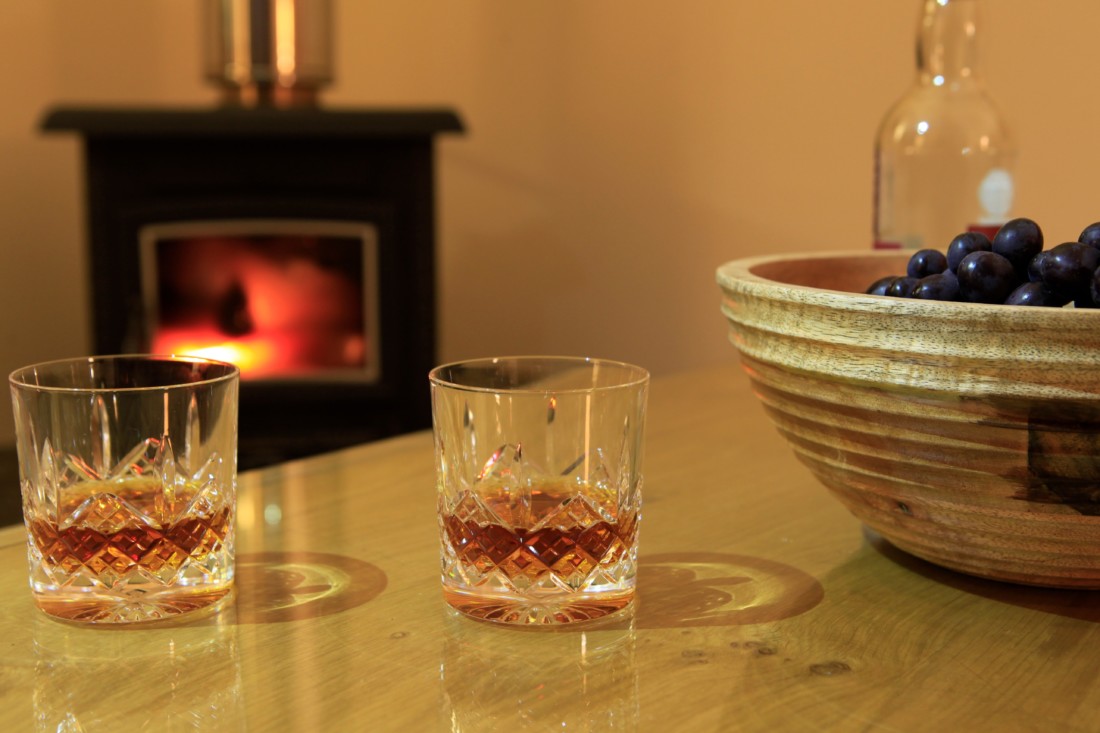 Capercaillie drinks in front of fire